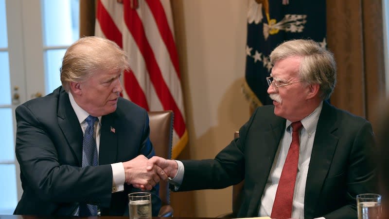 In this April 9, 2018 file photo, President Donald Trump, left, shakes hands with national security adviser John Bolton in the Cabinet Room of the White House in Washington at the start of a meeting with military leaders. Bolton recently opined that “If Trump is elected, there’ll be celebrations in the Kremlin. … Putin thinks that he is an easy mark.”