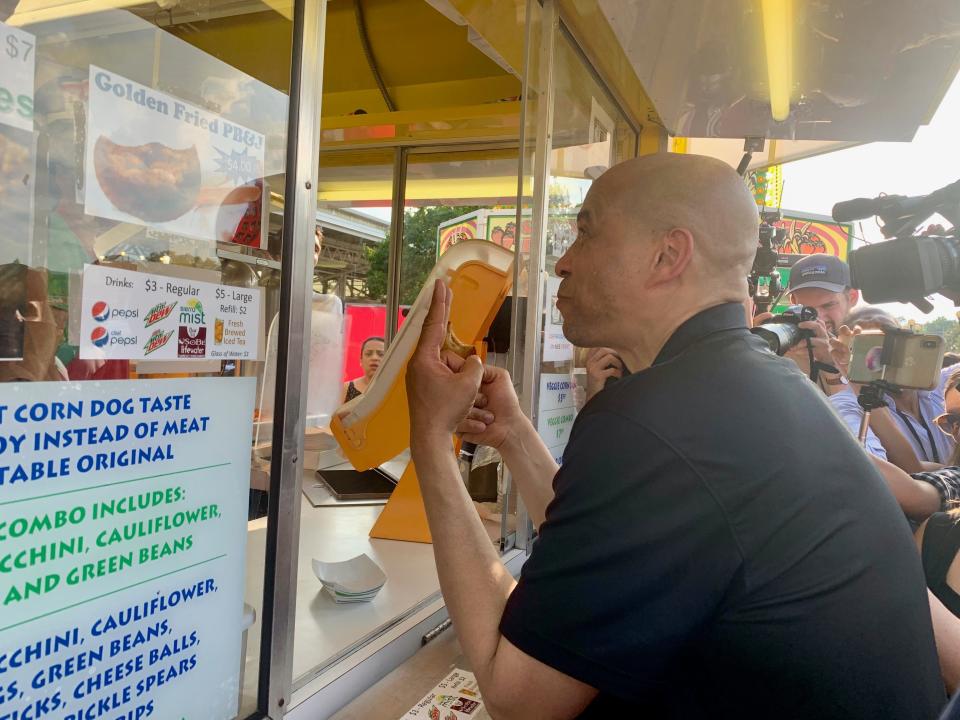 Cory Booker orders a second fried peanut butter and jelly sandwich at the Veggie Table booth in 2019.