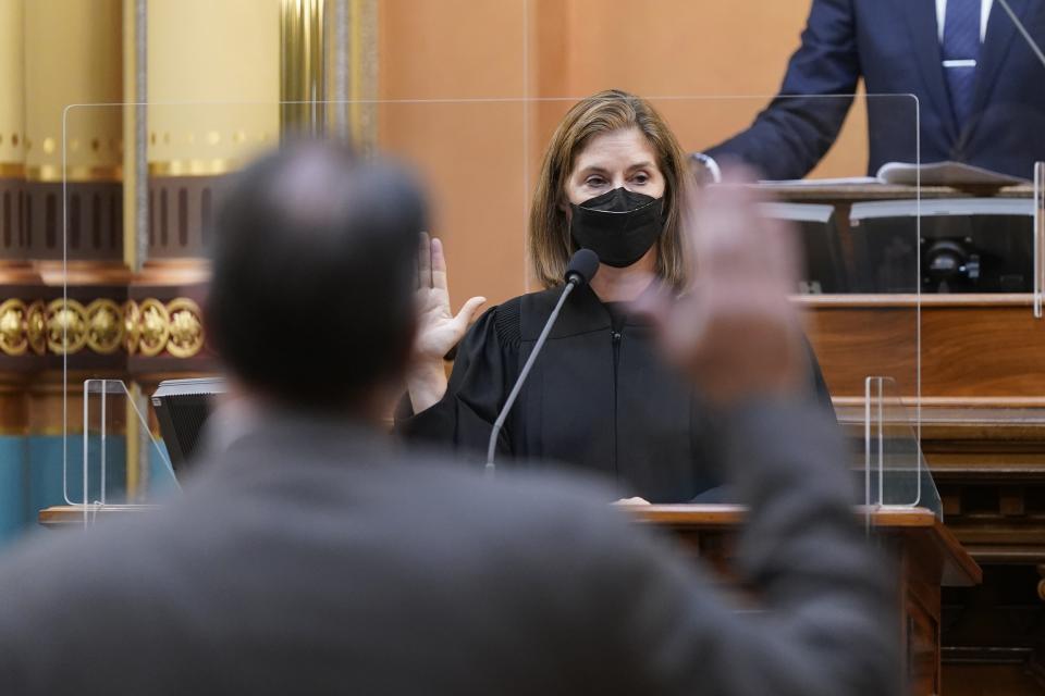 FILE - In this Dec. 14, 2020 photo, Michigan Supreme Court Chief Justice Bridget Mary McCormack swears in electors in the Electoral College at the state Capitol in Lansing, Mich. The Michigan Supreme Court heard arguments Wednesday, May 4, 2022 that could wipe out charges against former Gov. Rick Snyder and eight others in the Flint water scandal, as lawyers challenged a rarely used, century-old method to investigate crimes and file indictments.(AP Photo/Carlos Osorio, Pool, File)