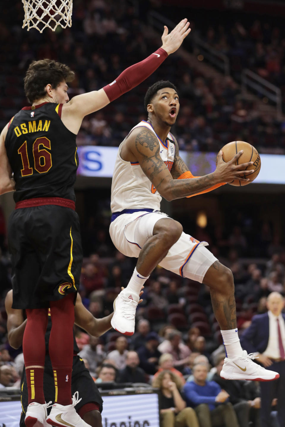 New York Knicks' Elfrid Payton (6) drives to the basket against Cleveland Cavaliers' Cedi Osman (16) in the second half of an NBA basketball game, Monday, Jan. 20, 2020, in Cleveland. New York won 106-86. (AP Photo/Tony Dejak)