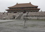 Artist Liu Bolin against a traditional Chinese temple back in Beijing.