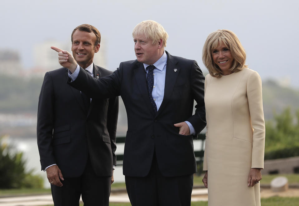 French President Emmanuel Macron and his wife Brigitte welcome Britain's Prime Minister Boris Johnson at the Biarritz lighthouse, southwestern France, ahead of a working dinner Saturday, Aug.24, 2019. Shadowed by the threat of global recession, a U.S. trade war with China and the possibility of one against Europe, the posturing by leaders of the G-7 rich democracies began well before they stood together for a summit photo. (AP Photo/Markus Schreiber)