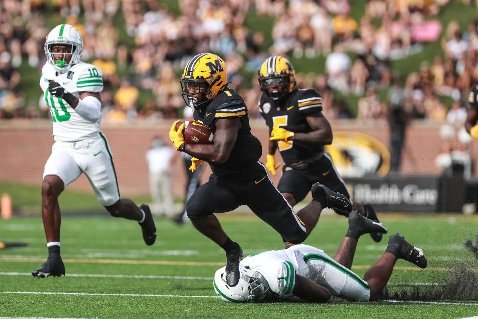 Missouri running back Tyler Badie (1) slips out of a tackle during the Tigers' game against the North Texas Mean Green Saturday at Faurot Field at Memorial Stadium in Columbia.