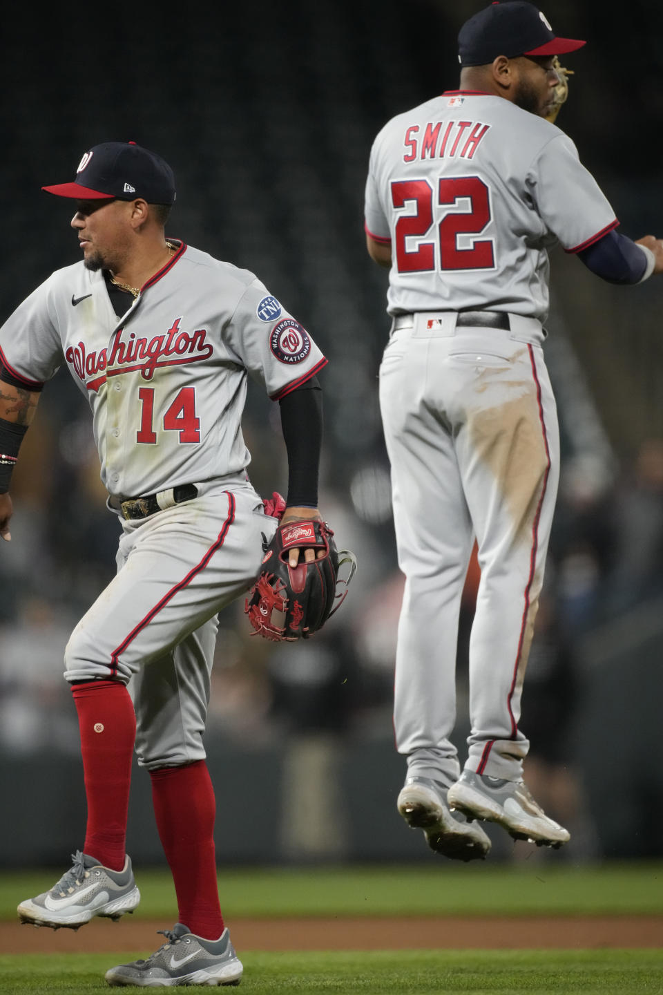 Washington Nationals second baseman Ildemaro Vargas, left, celebrates with first baseman Dominic Smith after the ninth inning of a baseball game against the Colorado Rockies,, Friday, April 7, 2023, in Denver. (AP Photo/David Zalubowski)