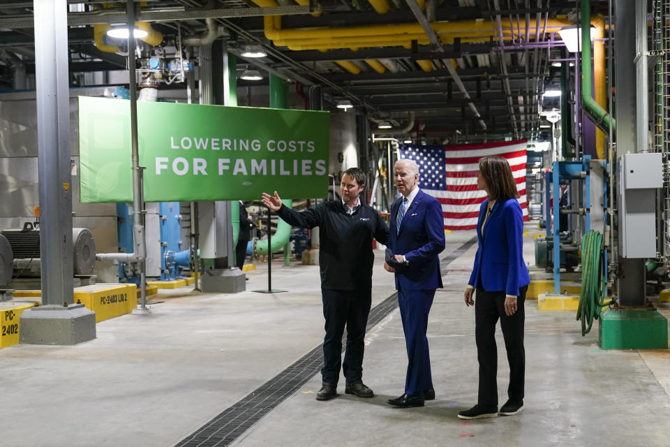 President Joe Biden and Rep. Cindy Axne, D-Iowa, talk with Jack Mitchell, regional vice president of POET Bioprocessing, left, as he gives them a tour at POET Bioprocessing in Menlo, Iowa, Tuesday, April 12, 2022. (AP Photo/Carolyn Kaster)