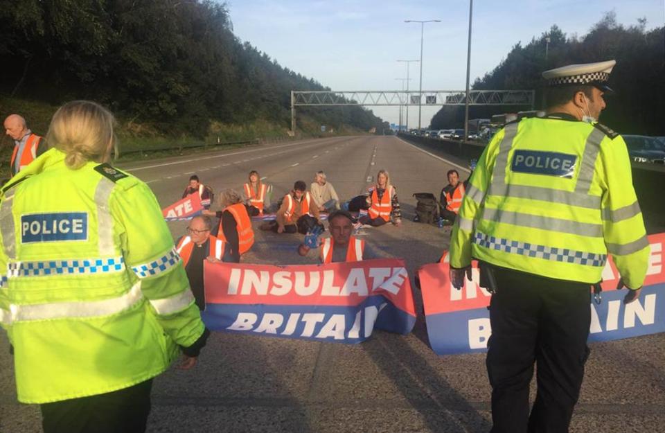 Handout photo issued by Insulate Britain of protesters occupying the clockwise and anti-clockwise lanes on the M25 in Surrey (PA Media)