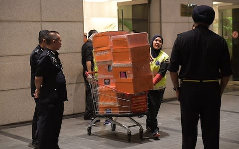 Malaysian police seize a huge haul of handbags belonging to Najib Razak's wife - Credit: Ariffin Jamar/AFP