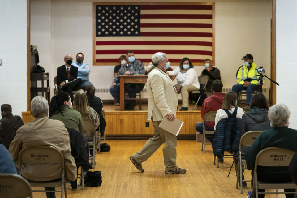 Lawyer and member of the Asatru Folk Assembly Allen Turnage returns to his seat, Wednesday, Oct. 14, 2020, in Murdock, Minn., after taking questions from the public and the council during a city council meeting for public discussion on the proposal to grant a permit to the Asatru Folk Assembly to use an old church they bought that only has a residential permit. The Asatru Folk Assembly considers themselves an ethnic religion, only allowing members who have Northern European heritage, the StarTribune reports. (Renee Jones Schneider/Star Tribune via AP)