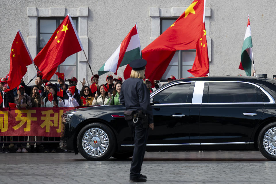People wave Chinese and Hungarian flags for the Chinese President Xi Jinping outside the Buda Castle in Budapest, Hungary, Thursday, May 9, 2024. (AP Photo/Denes Erdos)