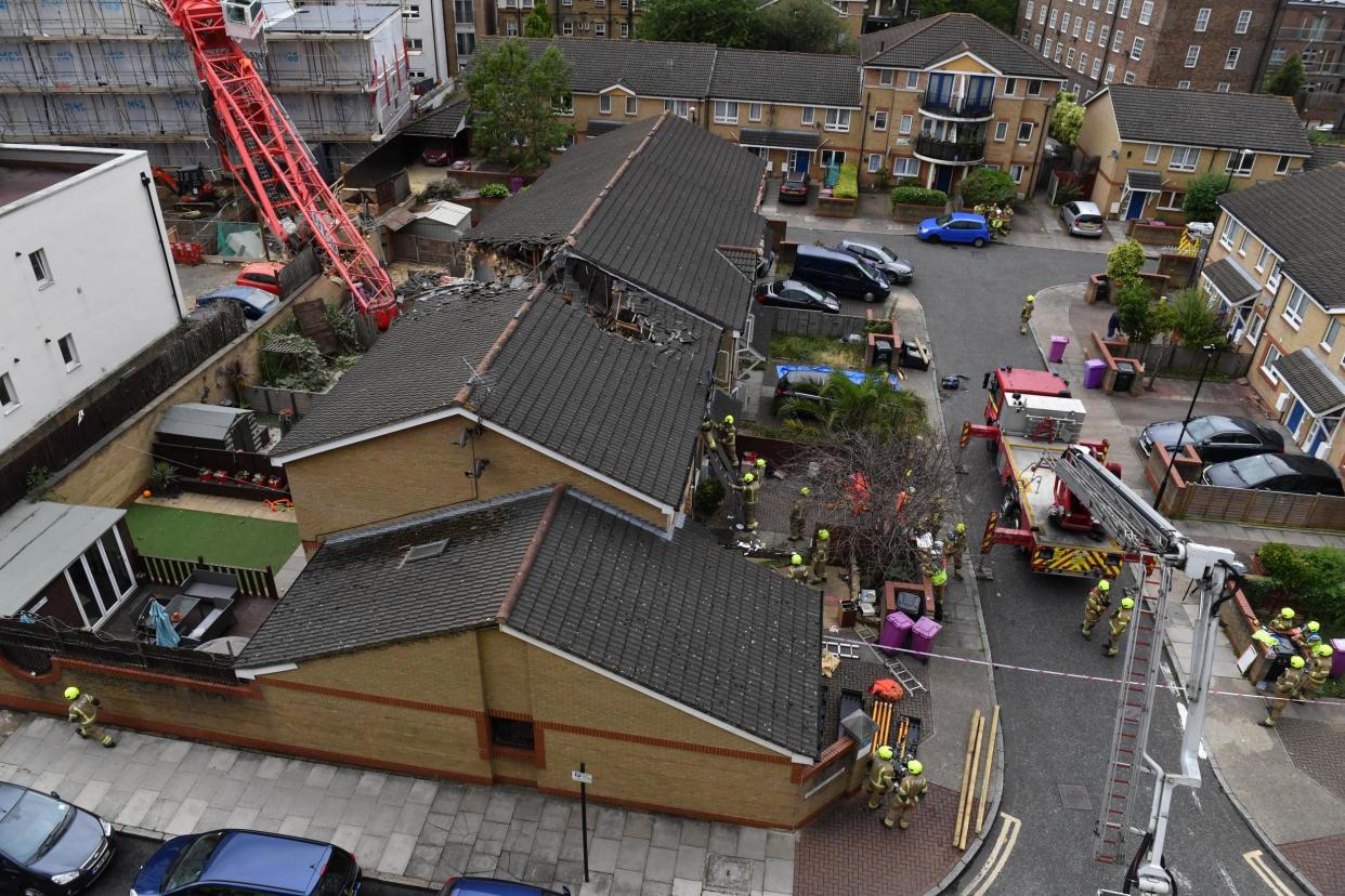 A 20-metre long crane has collapsed onto two houses in Bow: PA