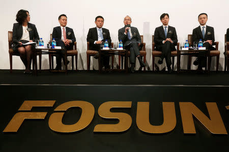 Fosun International Ltd Chairman Guo Guangchang (4th L) speaks at a news conference in Hong Kong, China March 29, 2017. REUTERS/Bobby Yip