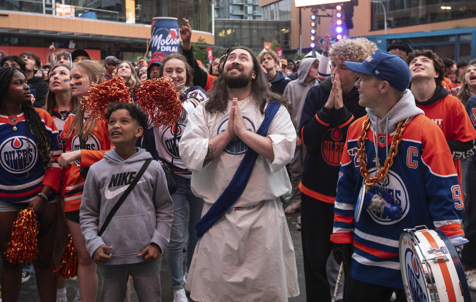 Edmonton Oilers fans watch coverage of Game 5 of the NHL hockey Stanley Cup Final between the Oilers and the Florida Panthers, Tuesday, June 18, 2024, in Edmonton, Alberta. (Jason Franson/The Canadian Press via AP)