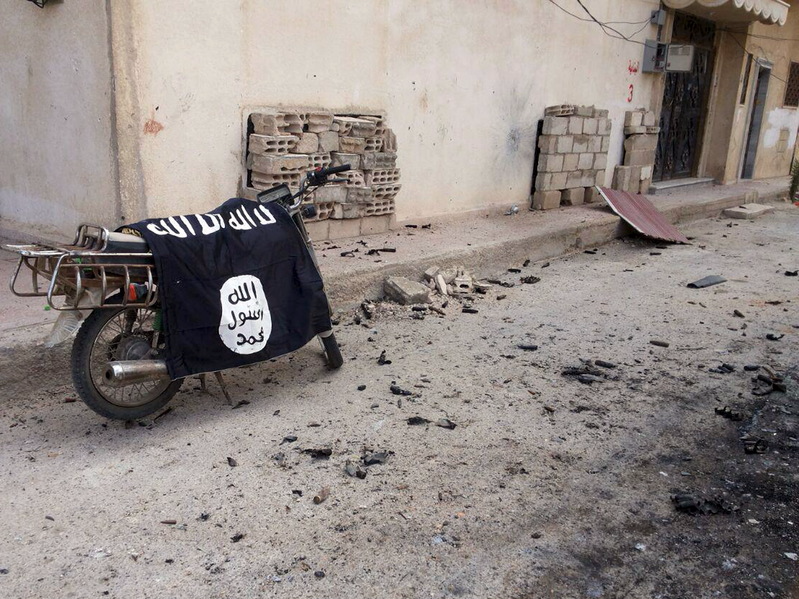 A flag belonging to the Islamic State fighters is seen on a motorbike after forces loyal to Syria's President Bashar al-Assad  recaptured the historic city of Palmyra, in Homs Governorate in this handout picture provided by SANA on March 27, 2016. REUTERS/SANA/Handout via Reuters 