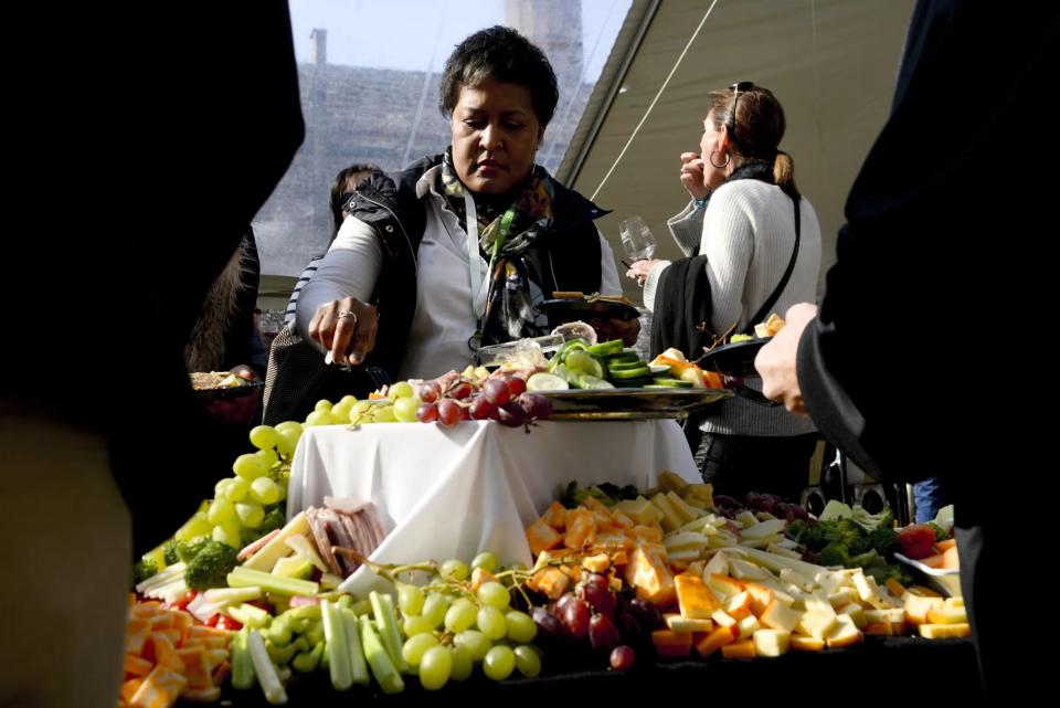 People pick out finger foods in the VIP section of Savannah Food and Wine Festival's flagship event, Taste of Savannah, at the Georgia State Railroad Museum on Saturday.