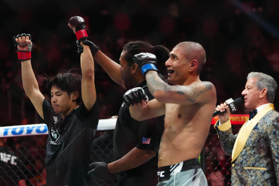 Jul 8, 2023; Las Vegas, Nevada, USA; Tatsuro Taira (red gloves) reacts to defeating Edgar Chairez (blue gloves) during UFC 290 at T-Mobile Arena. Mandatory Credit: Stephen R. Sylvanie-USA TODAY Sports