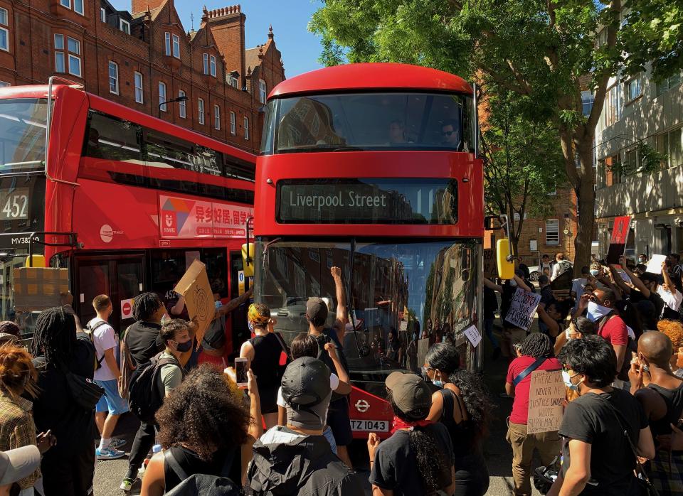 Demonstrators stop a bus as they block the street in Sloane Square in London on May 31, 2020 after marching on the US embassy to protest the death of George Floyd, an unarmed black man who died after a police officer knelt on his neck for nearly nine minutes during an arrest in Minneapolis, USA. - Hundreds gathered in central London and marched to the US Embassy to protest the death of an unarmed black man in Minneapolis while in police custody that has sparked days of unrest in the US city and beyond. (Photo by DANIEL LEAL-OLIVAS / AFP) (Photo by DANIEL LEAL-OLIVAS/AFP via Getty Images)