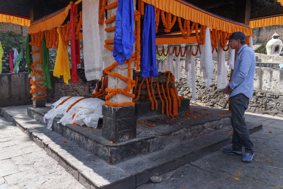 Partner Jim Morrison mourns next to the body during the funeral of famed American extreme skier Hilaree Nelson in Kathmandu, Nepal, Sunday, Oct.2, 2022. Nelson had died last week on Mount Manaslu while coming down from the top of the summit the 8,163-meter (26,775-foot) world's eighth-highest mountain. (AP Photo/Niranjan Shrestha)