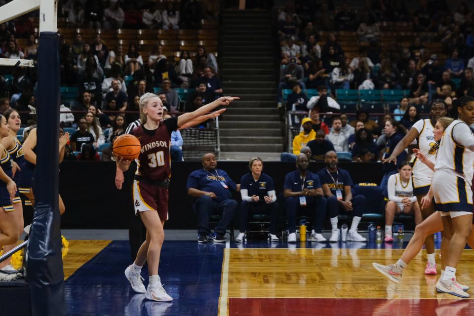 Windsor freshman shooting guard Nola Greenwald points before passing in the ball during the Colorado 5A girls basketball state championships Great 8 game against Northfield High School at the Denver Coliseum in Denver, Colo., on Friday, March 1, 2024.