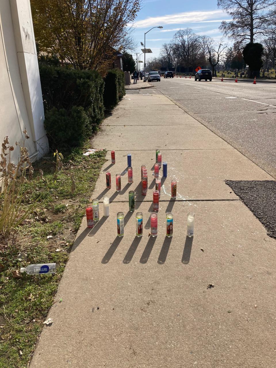 Candles are arranged outside Capital Academy, where a 14-year-old boy was gunned down after attending a birthday party at the Elks Lodge a block away.