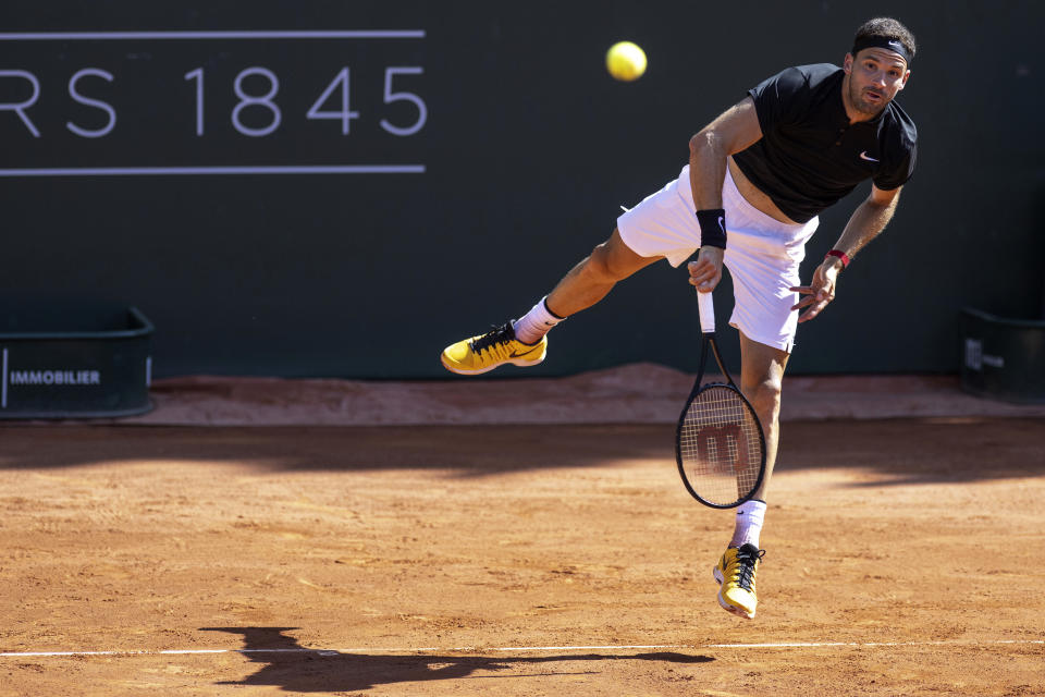 Bulgaria's Grigor Dimitrov returns a ball to Australia's Christopher O'Connell during their quarter-final match at the Geneva Open tennis tournament in Geneva, Switzerland, Thursday, May 25, 2023. (Martial Trezzini/Keystone via AP)