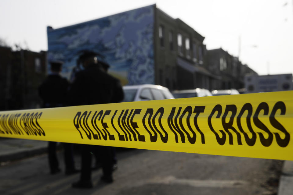 FILE - In this Nov. 19, 2018, file photo, police gather at the scene of a quadruple fatal shooting in Philadelphia. Philadelphia's homicide rate is the highest in over a decade, as a particularly violent summer morphed into a deadly fall and the mayor declared gun violence a public health emergency. (AP Photo/Matt Rourke, File)
