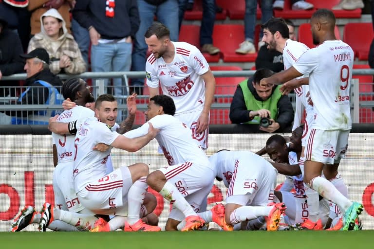 <a class="link " href="https://sports.yahoo.com/soccer/teams/stade-brest-29/" data-i13n="sec:content-canvas;subsec:anchor_text;elm:context_link" data-ylk="slk:Brest;sec:content-canvas;subsec:anchor_text;elm:context_link;itc:0">Brest</a> players celebrate after they netted a dramatic injury-time winner against <a class="link " href="https://sports.yahoo.com/soccer/teams/stade-rennes/" data-i13n="sec:content-canvas;subsec:anchor_text;elm:context_link" data-ylk="slk:Rennes;sec:content-canvas;subsec:anchor_text;elm:context_link;itc:0">Rennes</a> (Lou BENOIST)