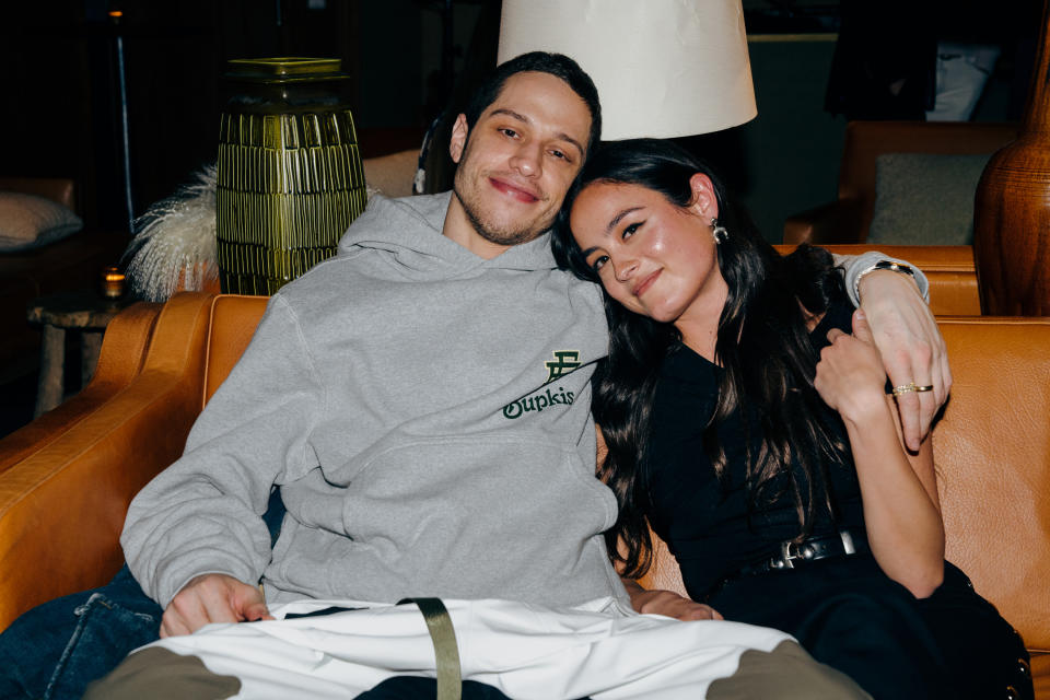 Pete and Chase smiling and sitting together on a couch