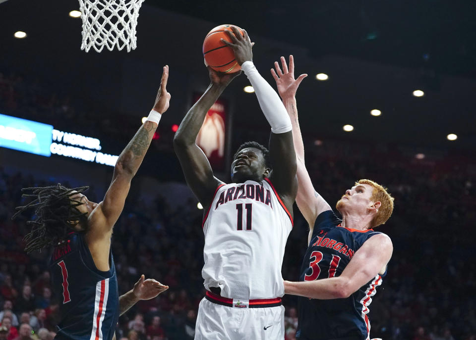 Arizona's Oumar Ballo (11) goes up to shoot against Morgan State's Khalil Turner (1) and Ty Horner (31) during the second half of an NCAA college basketball game, Thursday, Dec. 22, 2022, in Tucson, Ariz. (AP Photo/Darryl Webb)