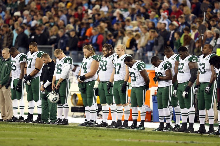 The New York Jets stand on the sideline in a moment of silence on December 17, 2012 for the victims of the mass shooting in Newtown, prior to the game against the Tennessee Titans. US athletes were quick to denounce the massacre, but a string of shootings involving star players indicates that many are avid gun owners who pack their heat wherever they go