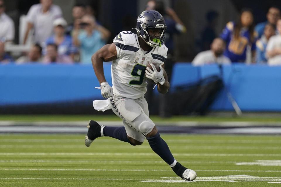 Seattle Seahawks running back Kenneth Walker III (9) runs in open field.