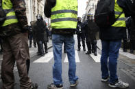 "Power to the People" is written on a yellow vest during a demonstration in Bourges, central France, Saturday, Jan. 12, 2019. The French Interior Ministry says about 32,000 people have turned out in yellow vest demonstrations across France, including 8,000 in Paris, where scuffles broke out between protesters and police. (AP Photo/Rafael Yaghobzadeh)