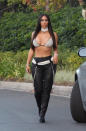 <p>Costume change! You didn’t think Kim would wear the same Halloween outfit to two different parties, did you? In true diva fashion, Kanye West’s wife channeled a third musical icon for her third party: the late singer Aaliyah. Kardashian rocked a barely there bikini top and black leather pants from the singer’s 2000 music video “Try Again.” (Photo: Splash News) </p>