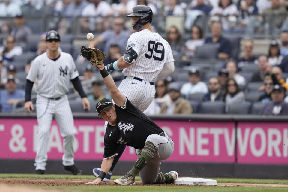 New York Yankees' Aaron Judge (99) beats the throw to Chicago White Sox first baseman Andrew Vaughn for a single during the first inning of a baseball game, Saturday, May 18, 2024, in New York. (AP Photo/Frank Franklin II)