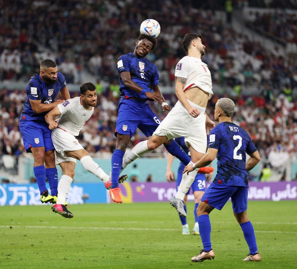 doha, qatar   november 29 yunus musah of united states  heads the ball against saeid ezatolahi of ir iran during the fifa world cup qatar 2022 group b match between ir iran and usa at al thumama stadium on november 29, 2022 in doha, qatar photo by dean mouhtaropoulosgetty images