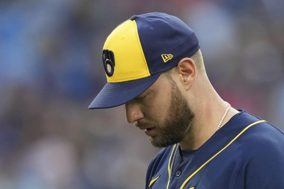 Milwaukee Brewers starting pitcher Adrian Houser heads to the dugout after the second inning of the team's baseball game against the Toronto Blue Jays o Tuesday, May 30, 2023, in Toronto. (Nathan Denette/The Canadian Press via AP)