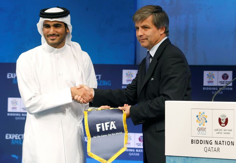 FILE PHOTO: Qatar 2022 World Cup bid chairman Sheikh Mohammed bin Hamad poses with Mayne-Nicholls, head of FIFA's six-man inspection team, in Doha