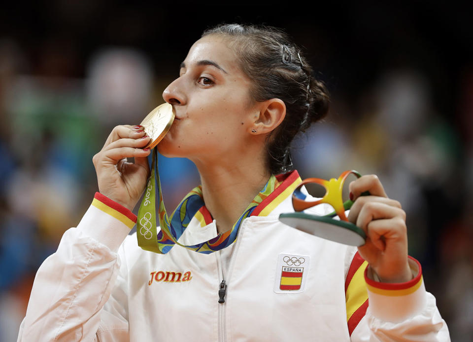 Spain's Carolina Marin kisses her gold medal during the medal ceremony for the women's badminton singles gold medal match at the 2016 Summer Olympics in Rio de Janeiro, Brazil. (Kin Cheung / AP)
