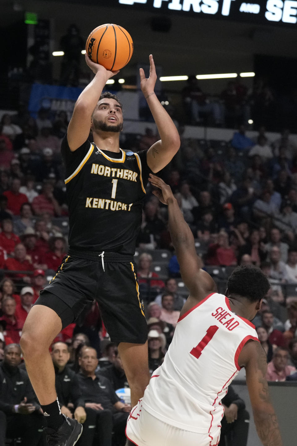 Northern Kentucky guard Trey Robinson (1) shoots over Houston guard Jamal Shead (1) during the first half of a first-round college basketball game in the men's NCAA Tournament in Birmingham, Ala., Thursday, March 16, 2023. (AP Photo/Rogelio V. Solis)