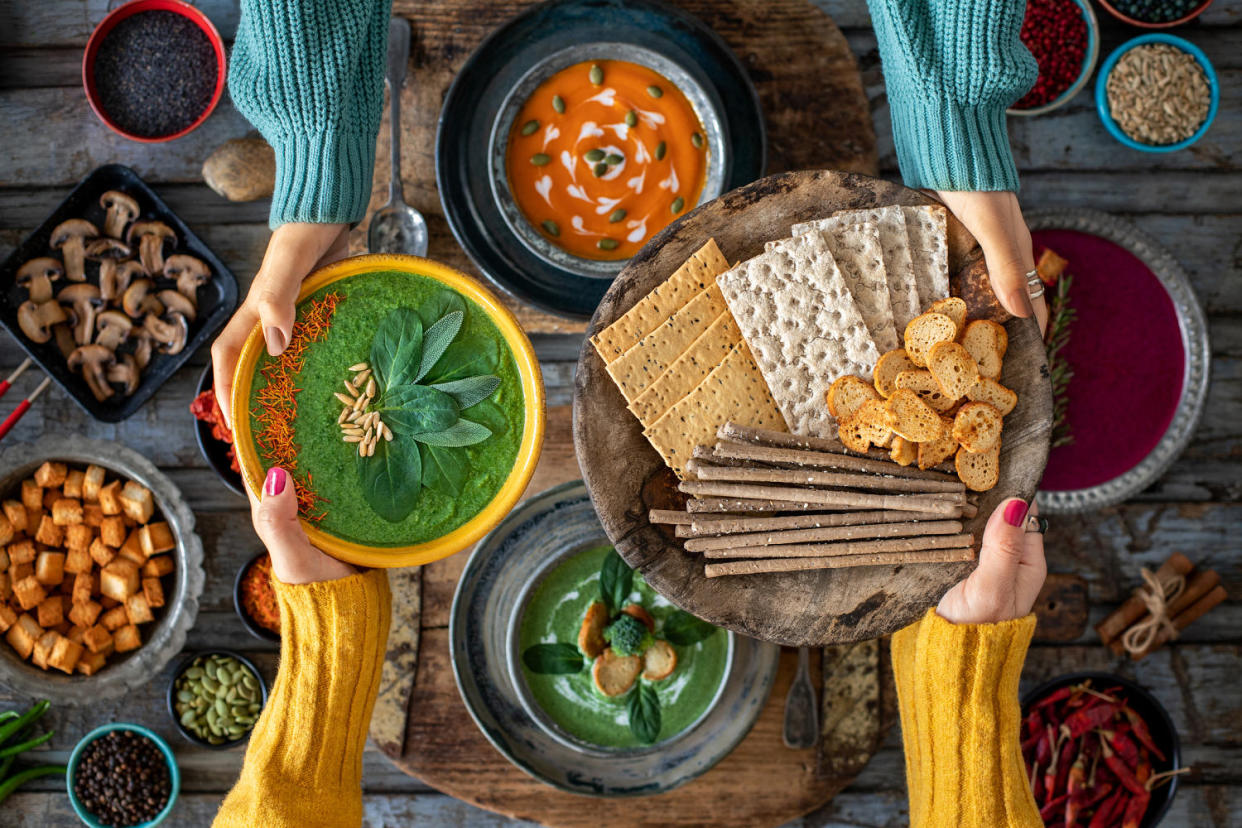 Two women sharing their vegetable soup and grissini breads. (Gulcin Ragiboglu / Getty Images)