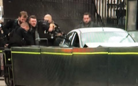 Armed police surround the car outside the Houses of Parliament - Credit: ITV