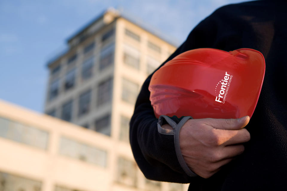 A Frontier Communications red hardhat.