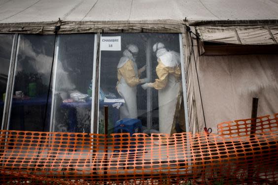 Health workers are seen inside the ‘red zone’ of an Ebola treatment centre in DRC (AFP via Getty Images)