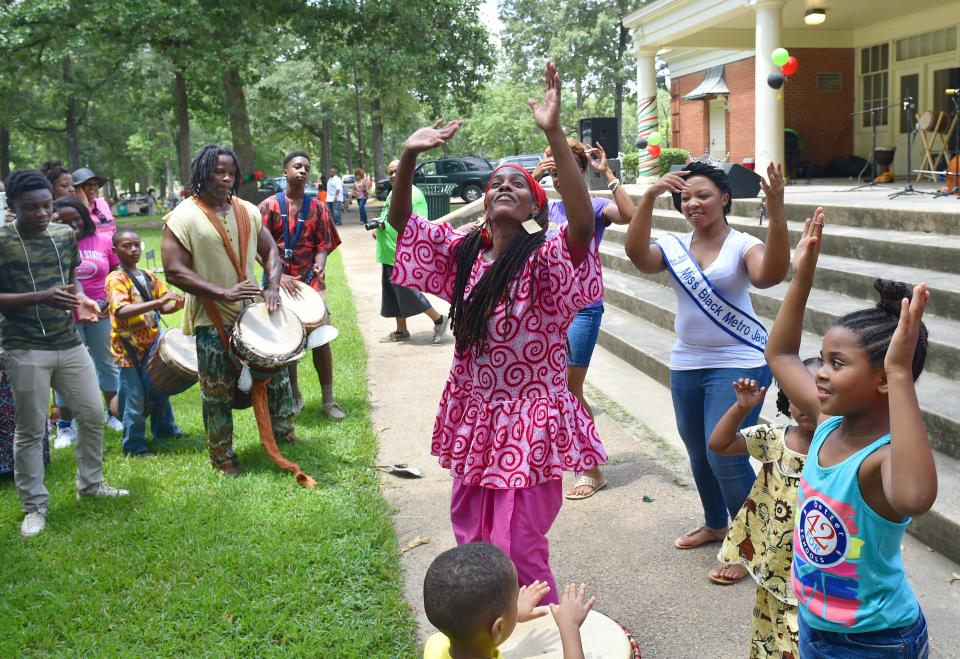 Chiquila Pearson and Jerry Jenkins, left, of Hasan Drums, leads Kuku or celebration dance during a past Jackson Juneteenth Celebration in Battlefield Park.