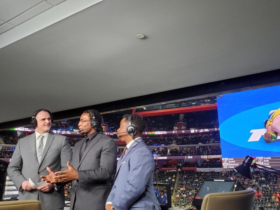 Shawn Kenney, left, announced the 2022 NCAA Championships. He is pictured here with analysts J'den Cox, center, and Rock Harrison, right, inside Little Caesars Arena in Detroit, Mich.