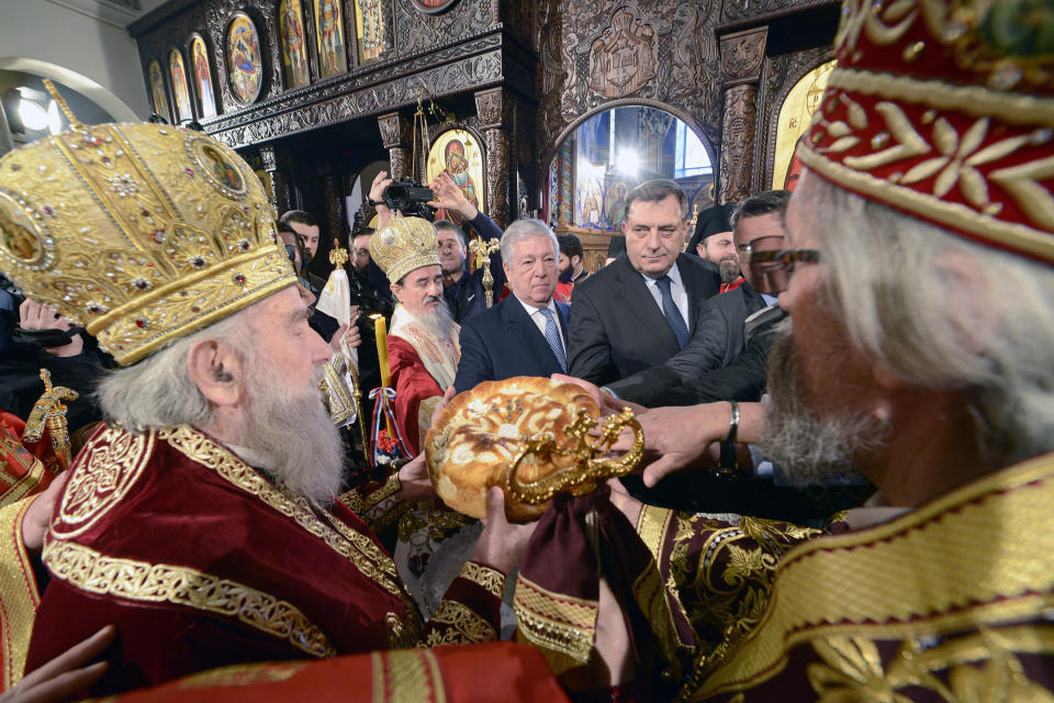 FILE- President of the Republic of Srpska Milorad Dodik, centre right, attends a traditional service in Orthodox Church marking the 25th anniversary of Republic of Srpska in Banja Luka, Bosnia, on Jan. 9, 2017. Long-reigning Bosnian Serb leader, Milorad Dodik, has grown increasingly hostile this week as the West turned up the pressure on him to stop a spiraling secessionist campaign in his multiethnic Balkan country of 3.3 million people that has never truly recovered from its fratricidal 1992-95 war. (AP Photo/Radivoje Pavicic, File)