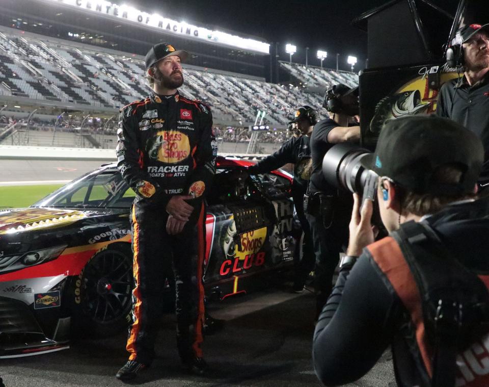 Martin Truex Jr. watches the action on the giant TV screne towering over pit road, Wednesday February 15, 2023 during Daytona 500 qualifying.