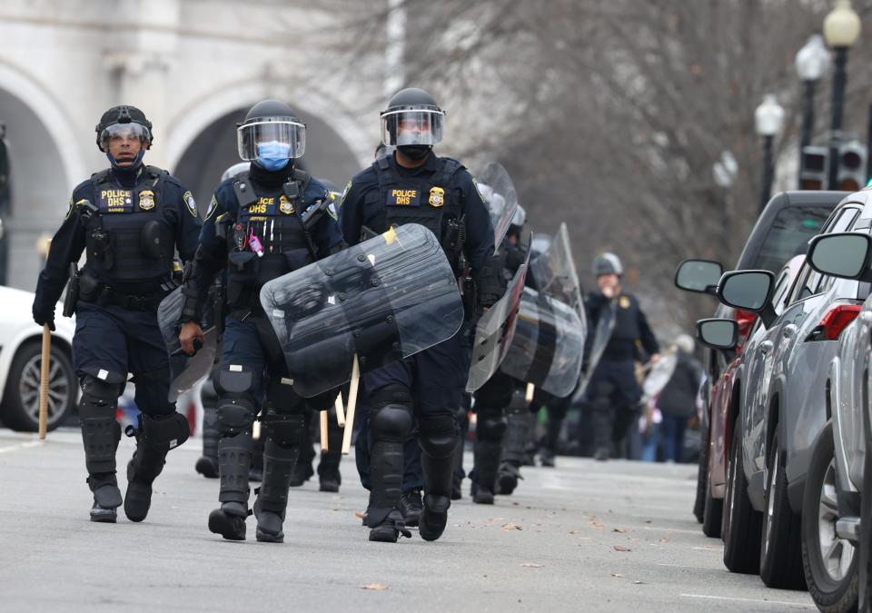 Police officers in riot gear walks towards the U.S. Capitol as protesters enter the building on Jan. 6, 2021, in Washington, DC. Trump supporters gathered in the nation's capital to protest the ratification of President-elect Joe Biden's Electoral College victory over President Trump in the 2020 election. (Photo by Tasos Katopodis/Getty Images)
