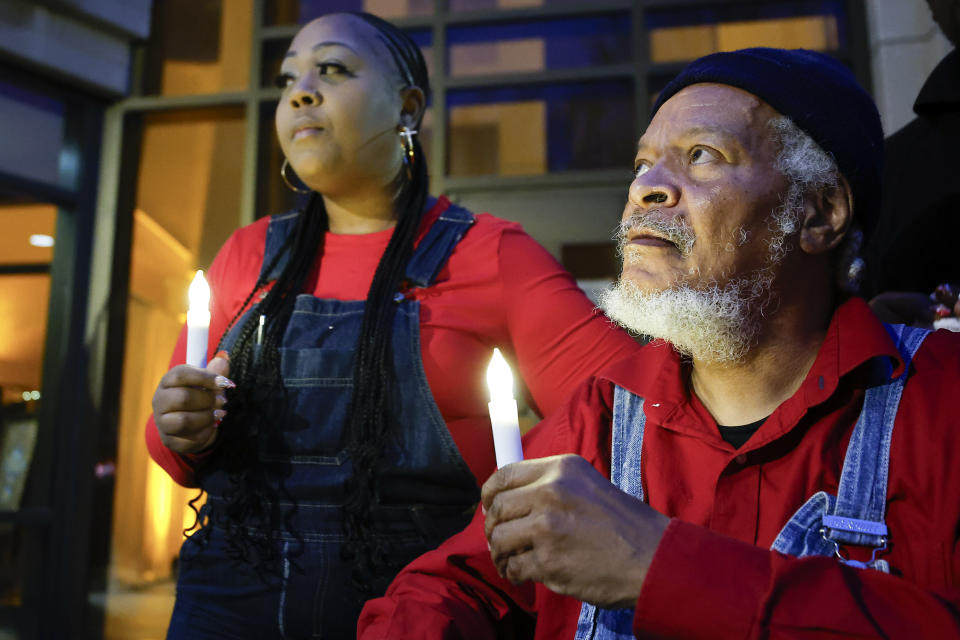 Shenita Binns, left, and Eric Terrell hold candles before a memorial service for Dexter Scott King, Saturday, Feb. 10, 2024, in Atlanta. King died in January, after battling prostate cancer. (AP Photo/Alex Slitz)