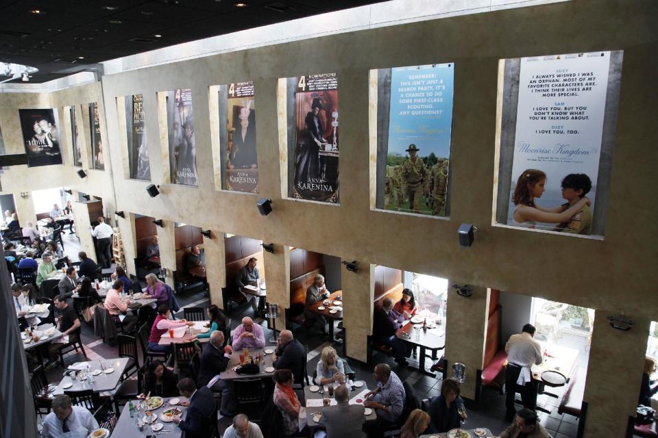 This Thursday, Feb. 21, 2013 photo shows people having lunch beneath Oscar posters at Kate Mantilini restaurant in Beverly Hills, Calif. The 85th Academy Awards are held on Sunday, Feb. 24, 2013, in Los Angeles. (AP Photo/Nick Ut)
