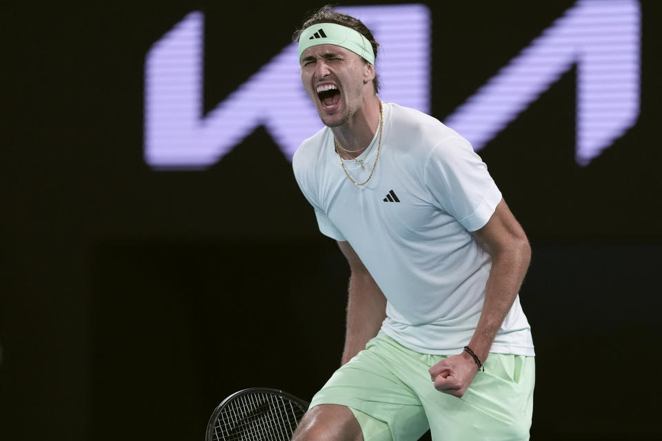 Alexander Zverev of Germany celebrates after defeating Carlos Alcaraz of Spain in their quarterfinal match at the Australian Open tennis championships at Melbourne Park, Melbourne, Australia, early Thursday, Jan. 25, 2024. (AP Photo/Andy Wong)